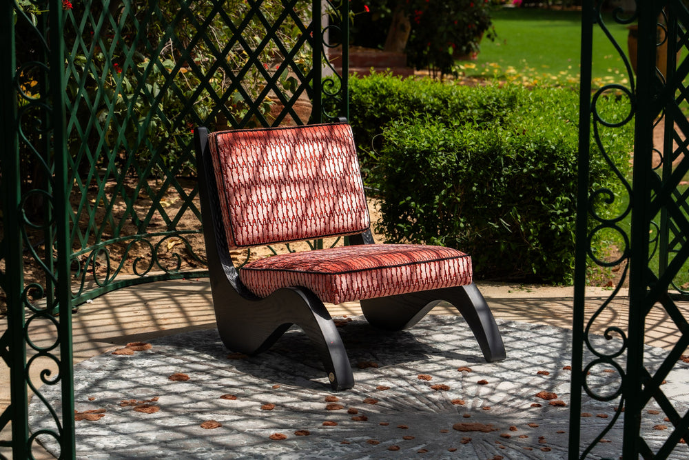Arae Red armchair in a garden setting