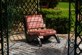 Arae Red armchair in a garden setting